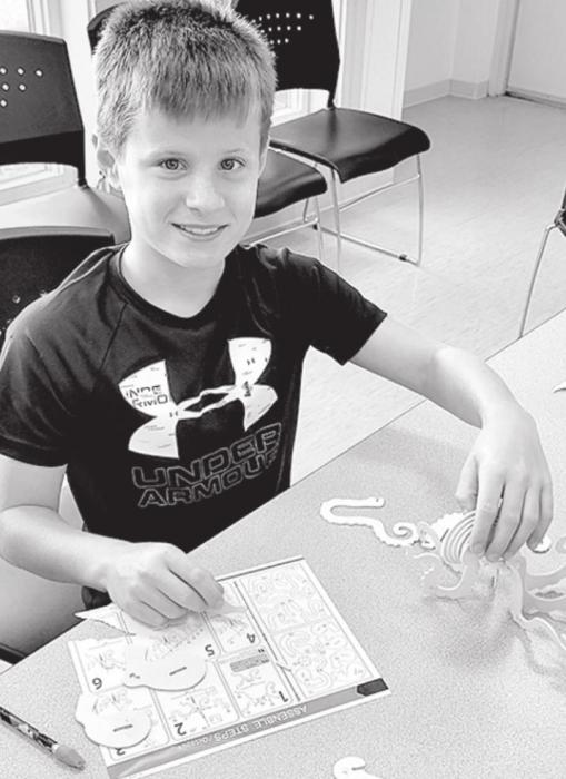 Will Konopasek puts together a 3-D puzzles of an octopus. Photos by Kelly Riibe